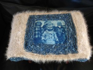 a footstool i made for my father. i made a cyanotype print on fabric, of himself, two of his sisters and a neighbor girl. the blue yarn is handspun soy silk that i dyed with indigo; the fawn yarn is the undercoat of our family dog, coby.